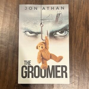 Paperback book- The Groomer by Jon Athan